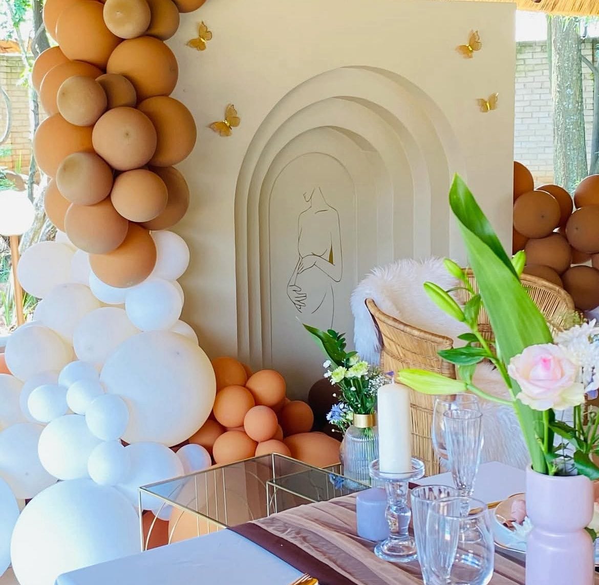Peach balloon arch with butterflies and soft styling