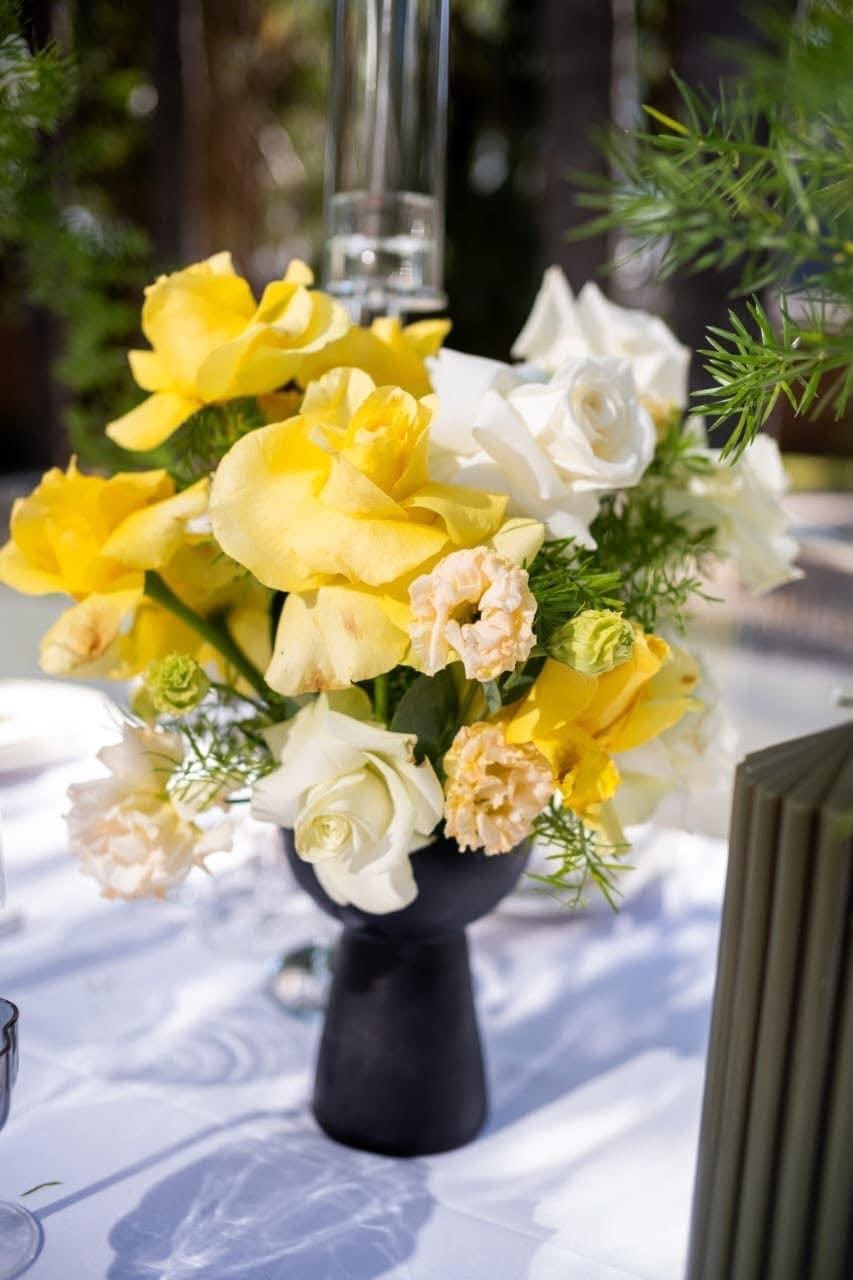 Outdoor event setup with draped tent and floral styling